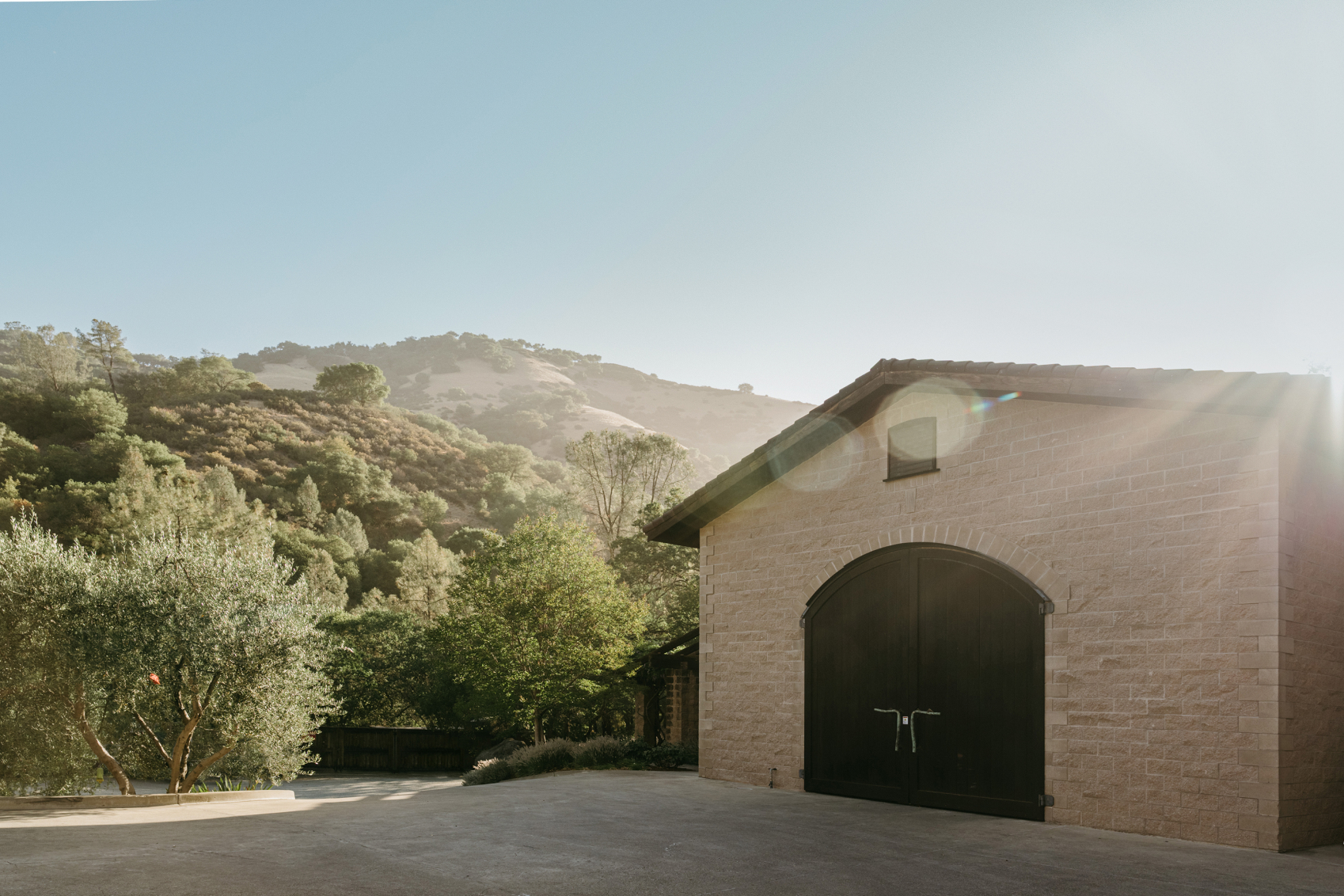 Building on Neyers winery property with mountains and a blue sky in the background