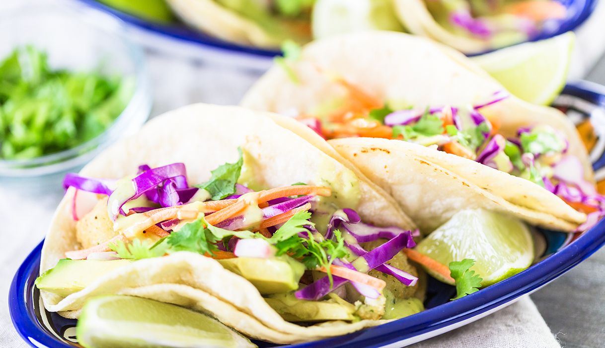 two fish tacos with slaw and cilantro crema